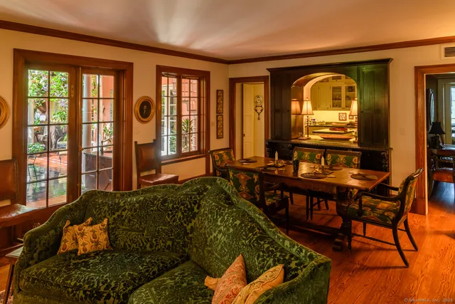 a living room with furniture and two windows