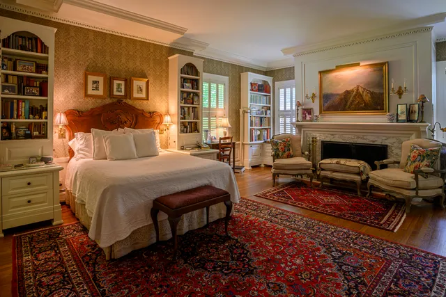 a bedroom with a bed and glass windows