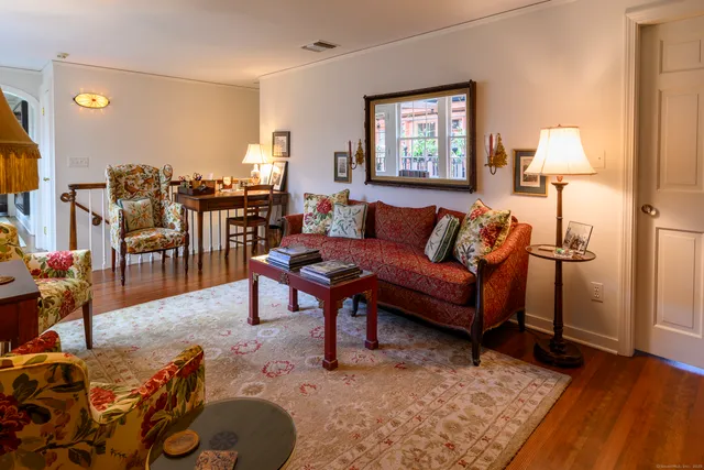 a living room with furniture a lamp and a table