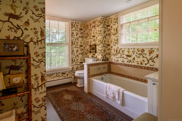 a bathroom with a bathtub sink and window