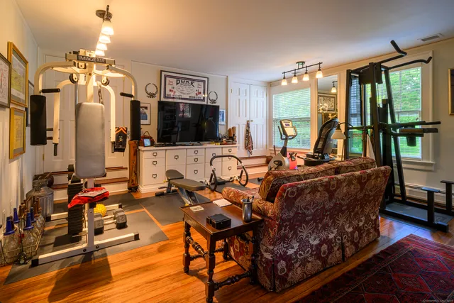 a living room with furniture flat screen tv and a large window