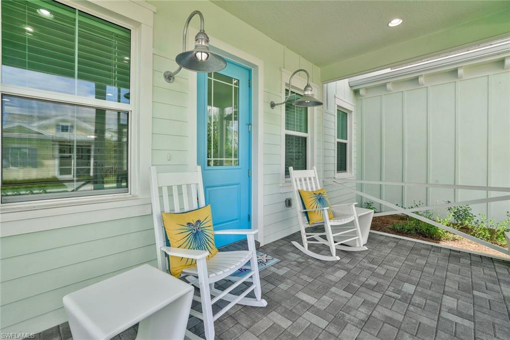 7295 Cayo Coco Lane Naples, FL 34113 - Photo 1 of 16 a balcony with chairs and table