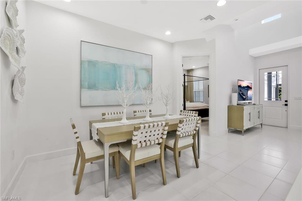 7295 Cayo Coco Lane Naples, FL 34113 - Photo 11 of 16 a dining room with furniture and window