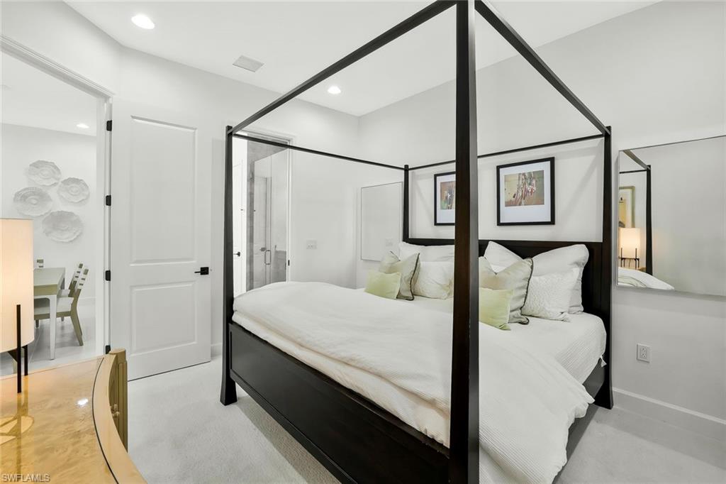 7295 Cayo Coco Lane Naples, FL 34113 - Photo 12 of 16 a bedroom with a bed and wooden floor