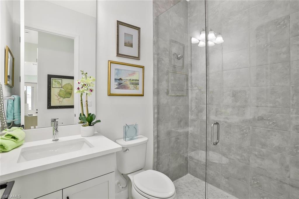 7295 Cayo Coco Lane Naples, FL 34113 - Photo 15 of 16 a bathroom with a toilet sink and shower