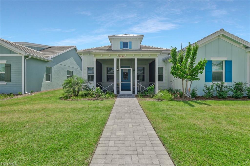7295 Cayo Coco Lane Naples, FL 34113 - Photo 2 of 16 a front view of a house with garden