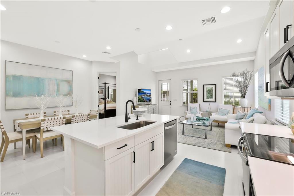 7295 Cayo Coco Lane Naples, FL 34113 - Photo 7 of 16 a large white kitchen with a large window