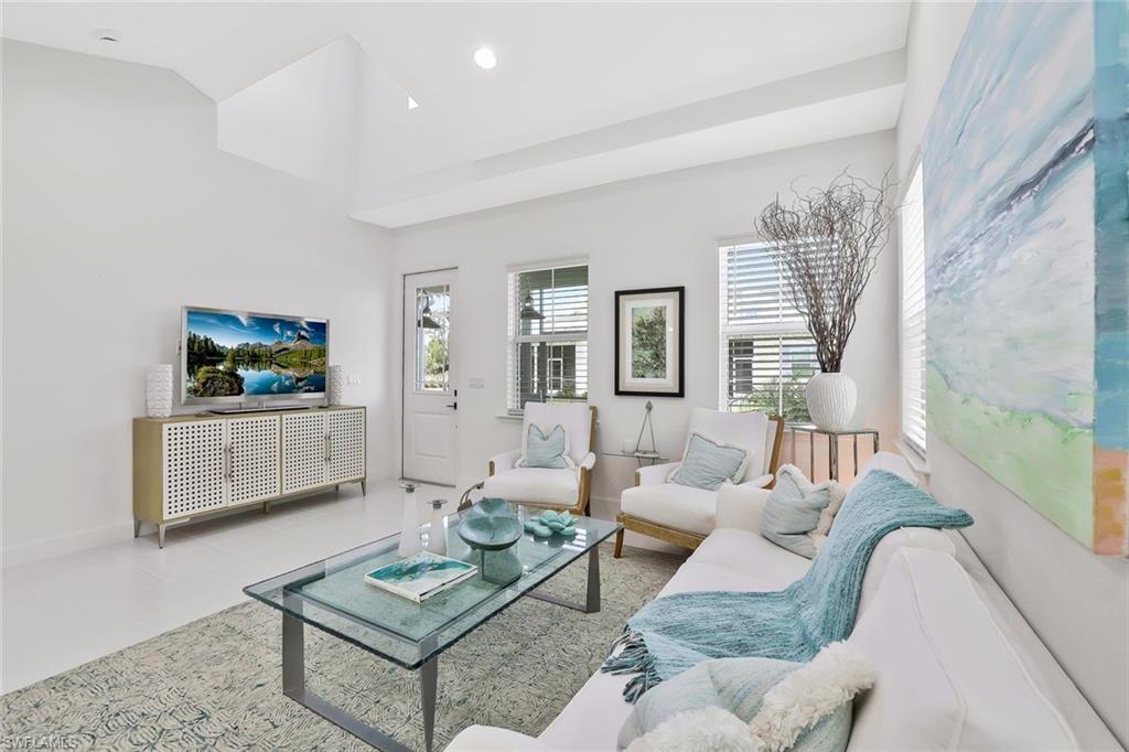 7295 Cayo Coco Lane Naples, FL 34113 - Photo 8 of 16 a living room with furniture and a flat screen tv