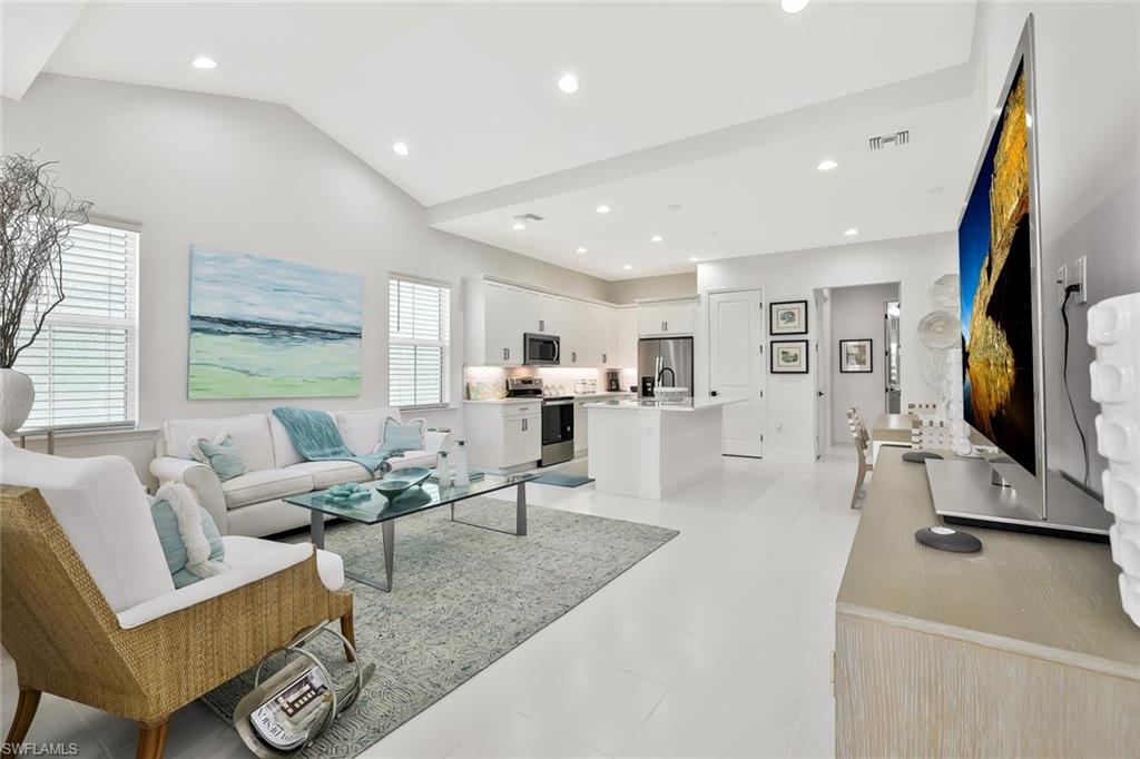 7295 Cayo Coco Lane Naples, FL 34113 - Photo 9 of 16 a living room with furniture and a flat screen tv