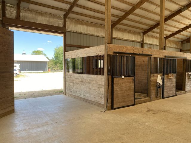 a kitchen with stainless steel appliances granite countertop a stove and a wooden floors