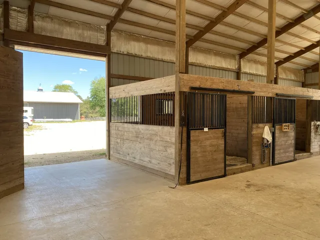 a kitchen with stainless steel appliances granite countertop a stove and a wooden floors