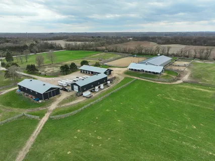 an aerial view of a house with garden space and street view