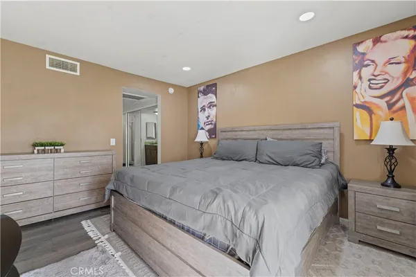 a bedroom with a large bed and a dresser