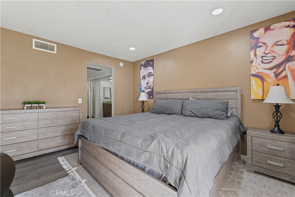 23515 Lyons Avenue, Unit 277 Valencia, CA 91355 - Photo 12 of 29 a bedroom with a large bed and a dresser