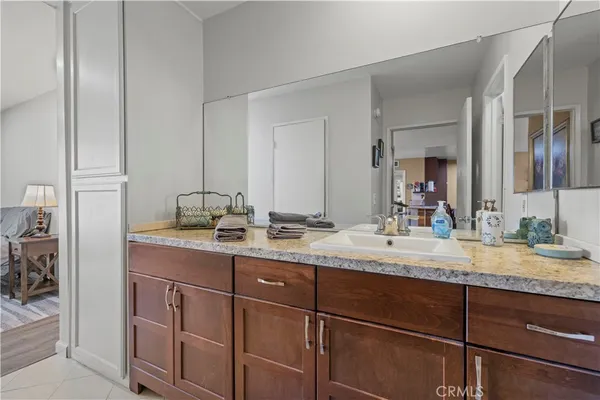 a bathroom with a granite countertop sink double and mirror