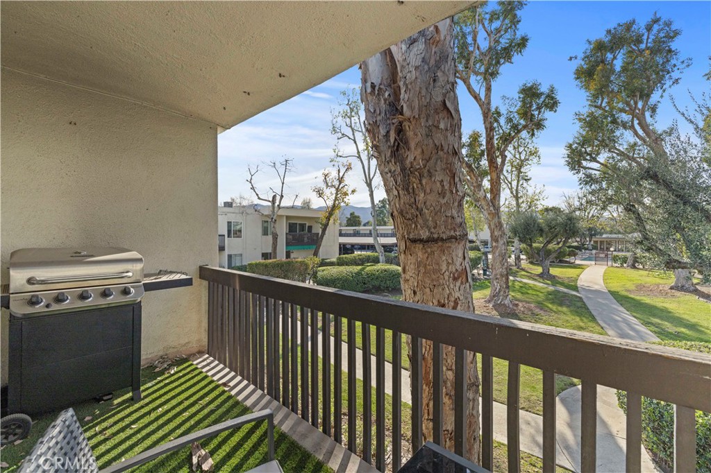 23515 Lyons Avenue, Unit 277 Valencia, CA 91355 - Photo 19 of 29 a view of a balcony with wooden floor and fence
