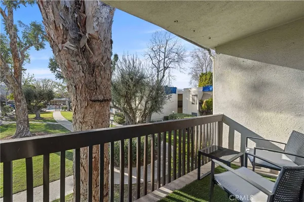 a view of a balcony with wooden floor and outdoor space