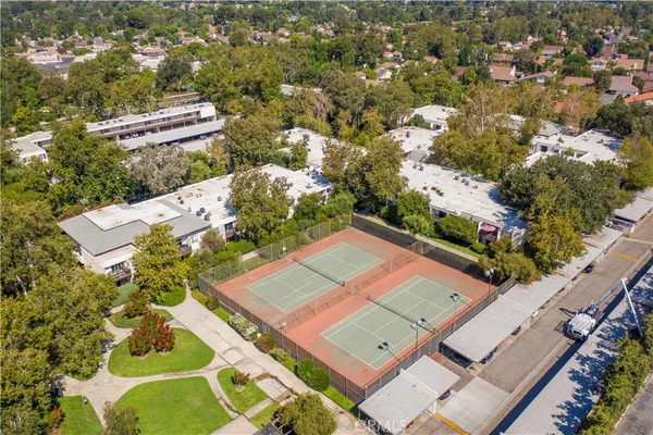 an aerial view of a house with a yard and garden