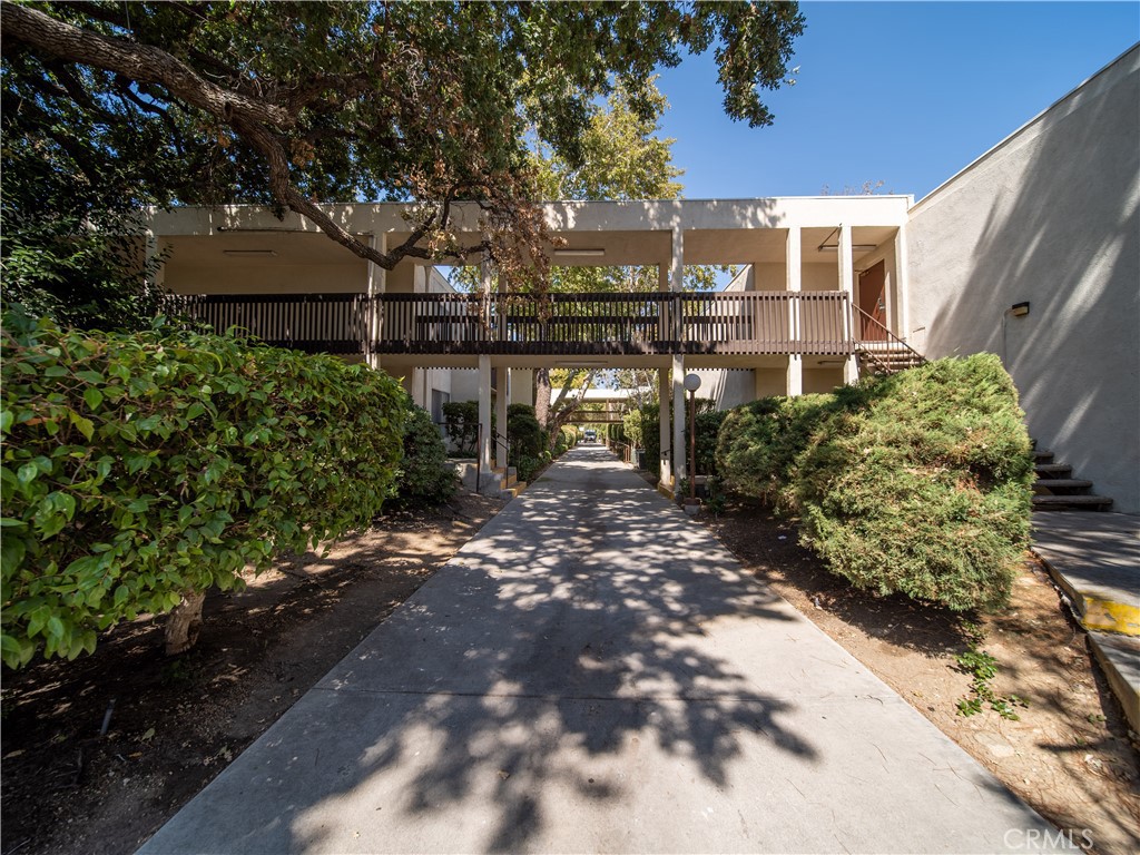 23515 Lyons Avenue, Unit 277 Valencia, CA 91355 - Photo 26 of 29 a view of a house with a yard