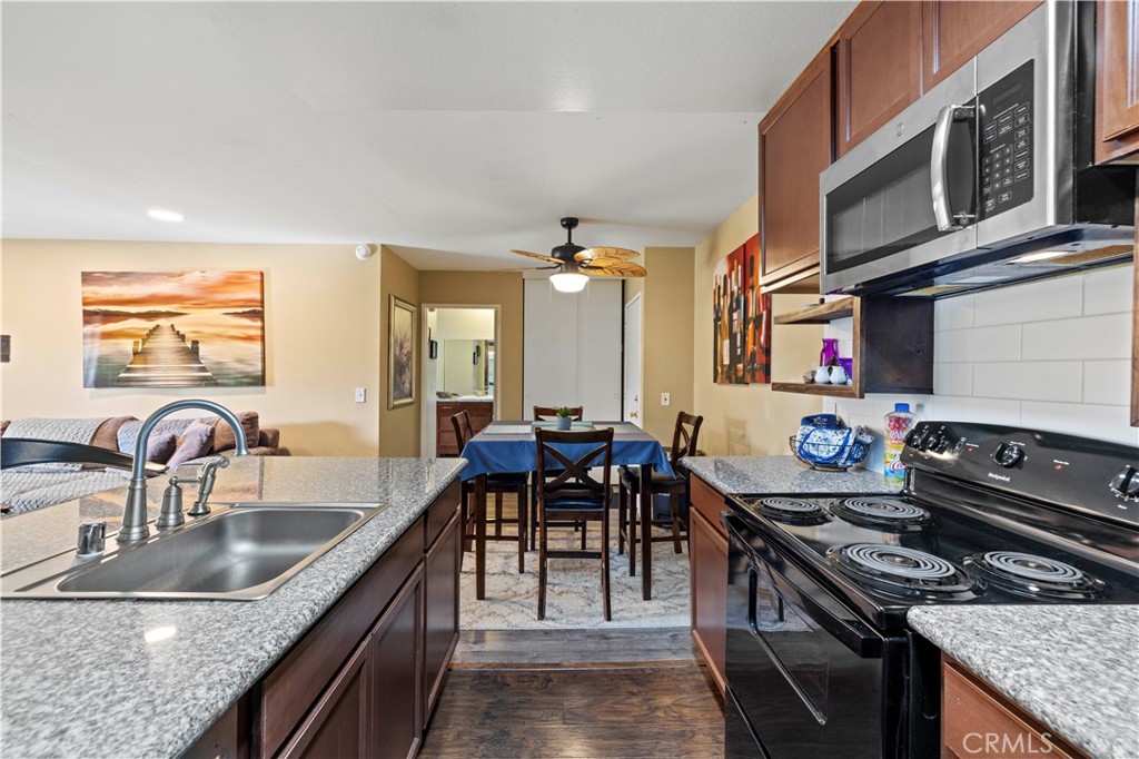 23515 Lyons Avenue, Unit 277 Valencia, CA 91355 - Photo 7 of 29 a kitchen with stainless steel appliances granite countertop a sink stove and cabinets