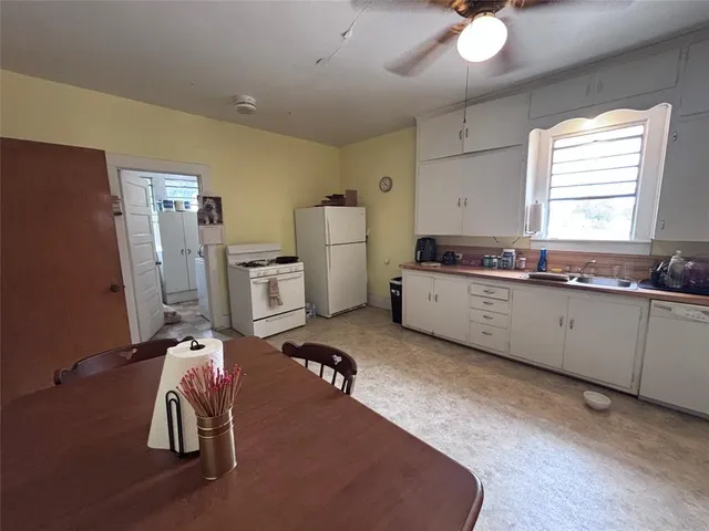 a kitchen with a sink appliances and cabinets