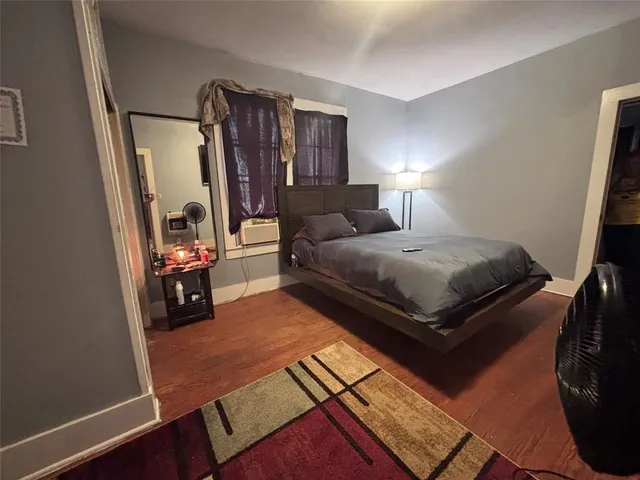 a bedroom with a bed and a lamp