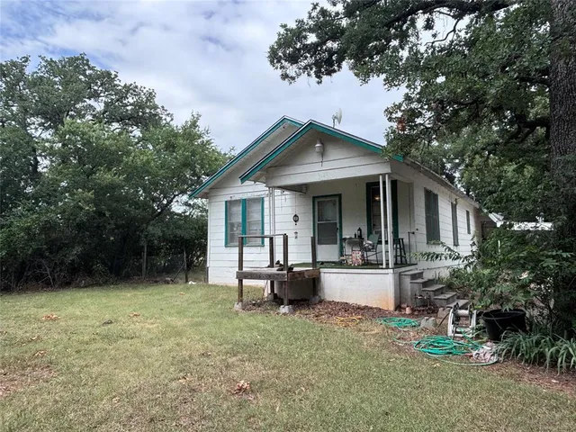 a front view of house with yard and seating area