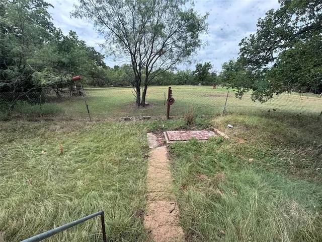 a backyard of a house with lots of green space