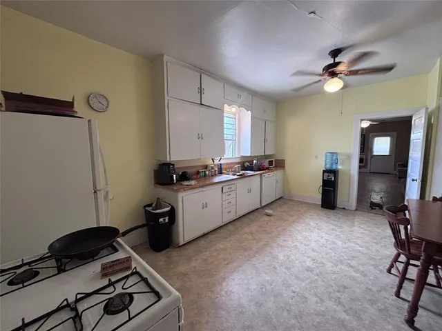 a kitchen with a sink appliances and cabinets