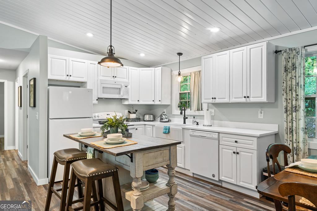 270 Hiawassee River Road Murphy, NC 28906 - Photo 11 of 50 a kitchen with a white center island and cabinets