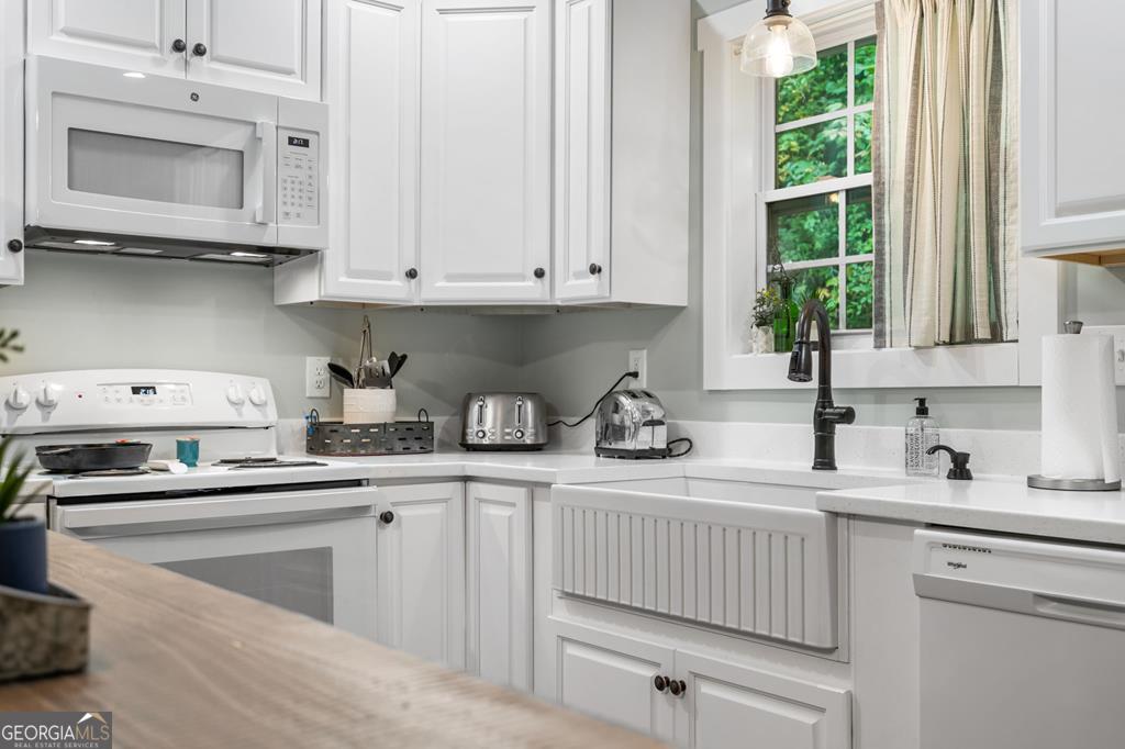 270 Hiawassee River Road Murphy, NC 28906 - Photo 12 of 50 a kitchen with stainless steel appliances granite countertop a sink a stove and cabinets