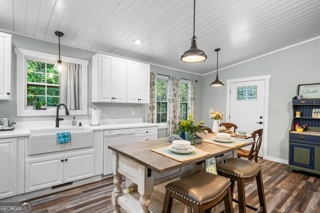 270 Hiawassee River Road Murphy, NC 28906 - Photo 16 of 50 a kitchen with a table chairs stove and microwave