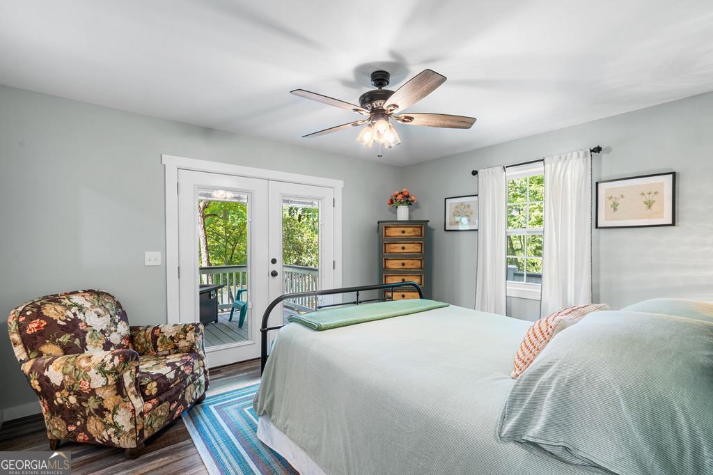 270 Hiawassee River Road Murphy, NC 28906 - Photo 19 of 50 a bedroom with a large bed and a chandelier