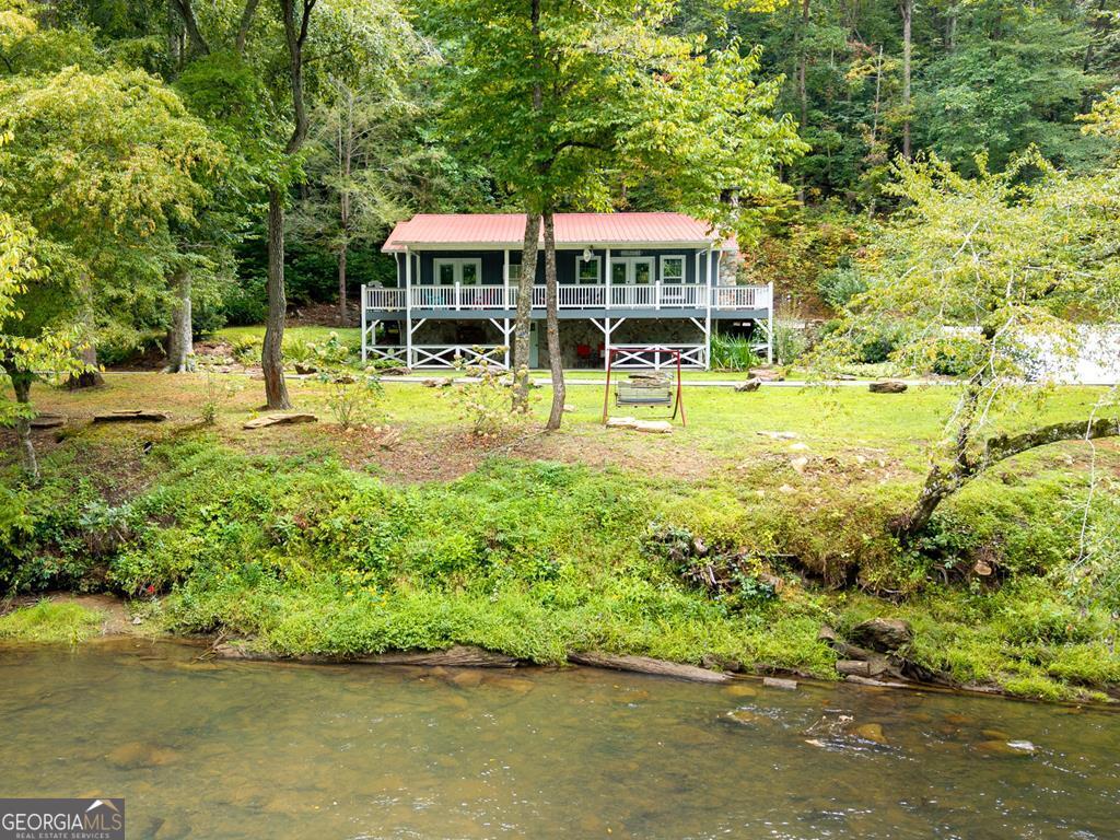 270 Hiawassee River Road Murphy, NC 28906 - Photo 38 of 50 a view of a swimming pool with lawn chairs and plants