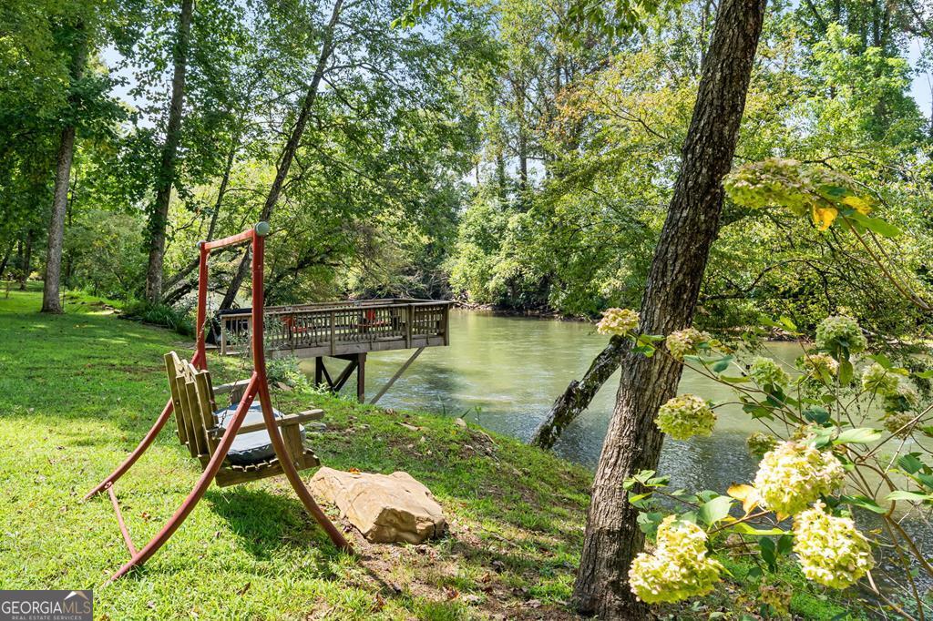 270 Hiawassee River Road Murphy, NC 28906 - Photo 42 of 50 a backyard of a house with table and chairs