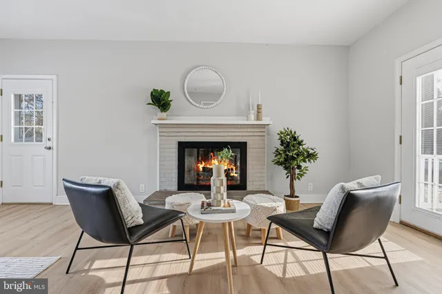 a view of a livingroom with furniture and a fireplace