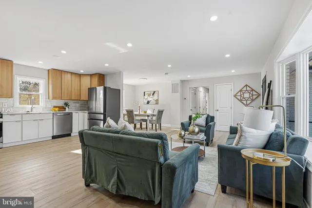 a living room with fireplace furniture and a wooden floor