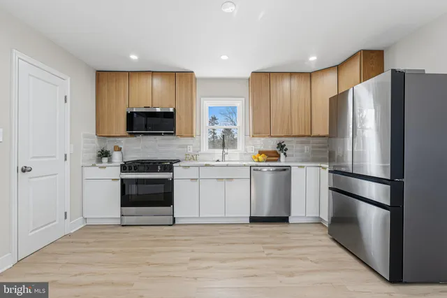 a kitchen with a refrigerator stove and a sink