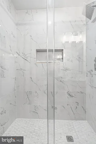 an empty room with wooden floor and window