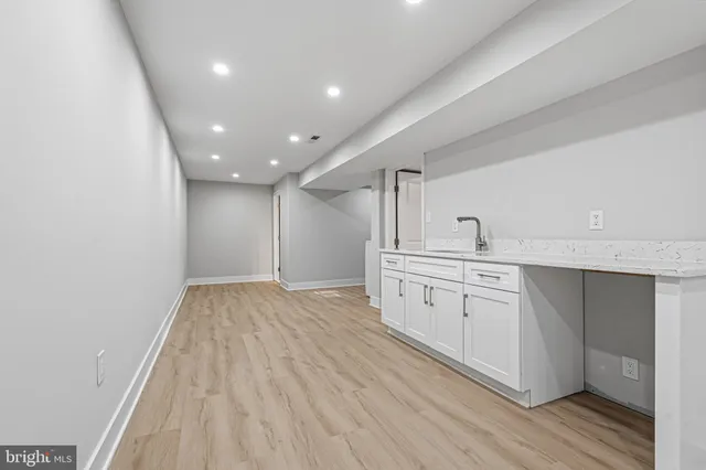 a view of a kitchen with wooden floor and washing machine