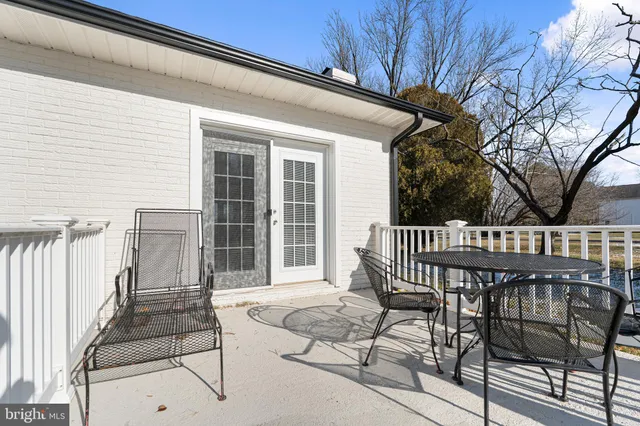 a view of balcony with wooden floor and outdoor seating