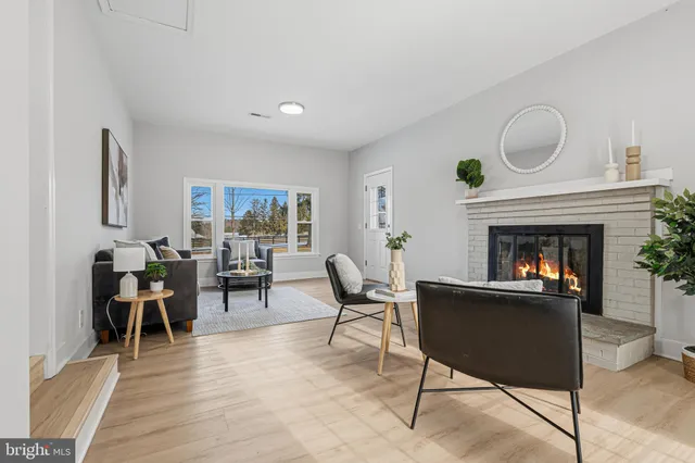a living room with furniture a fireplace and a table