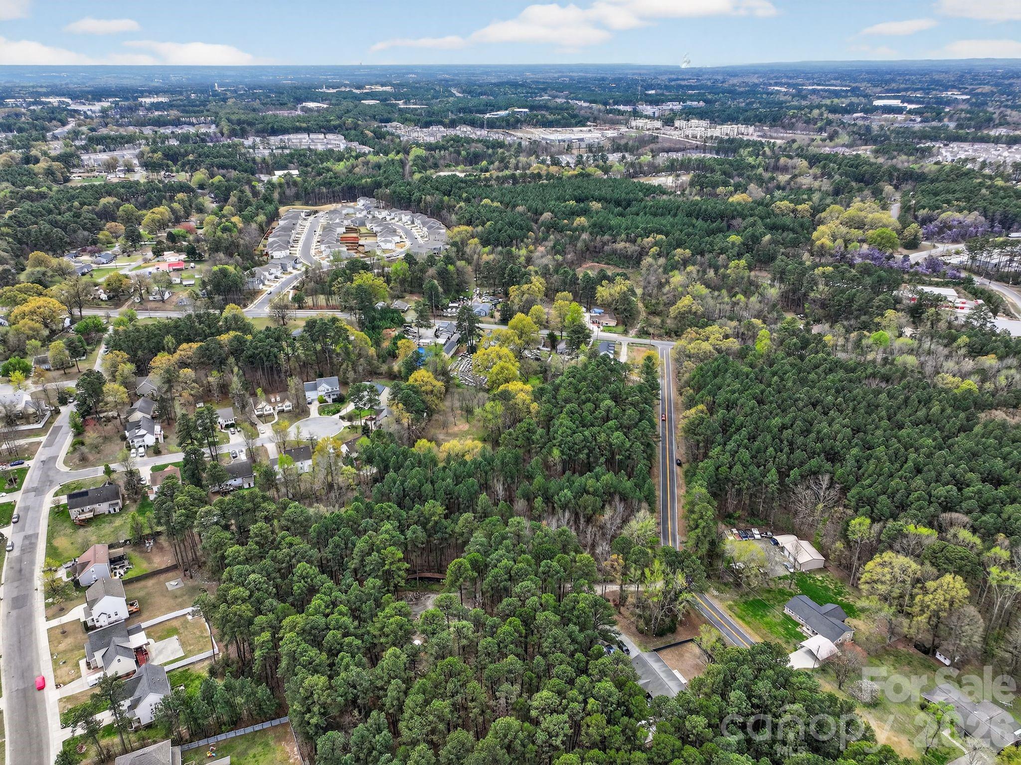 1535 Ruritan Road Durham, NC 27703 - Photo 5 of 10 an aerial view of a houses with a lush green hillside
