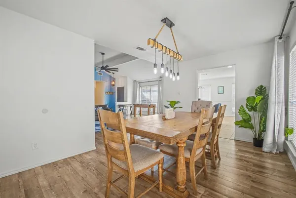 a view of a dining room with furniture and wooden floor
