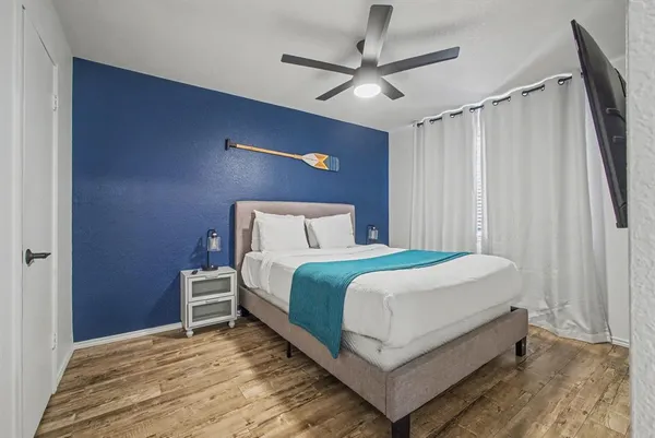 a bedroom with a bed and a chandelier