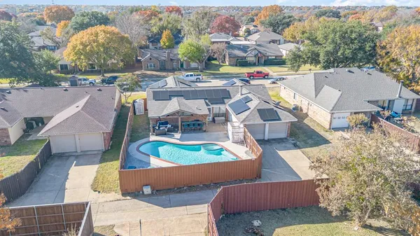 an aerial view of residential houses with outdoor space and parking