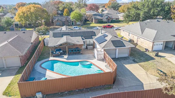 an aerial view of a house with swimming pool