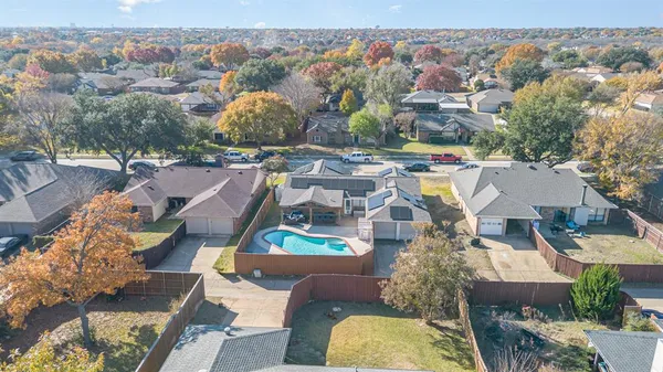 an aerial view of a house with a yard