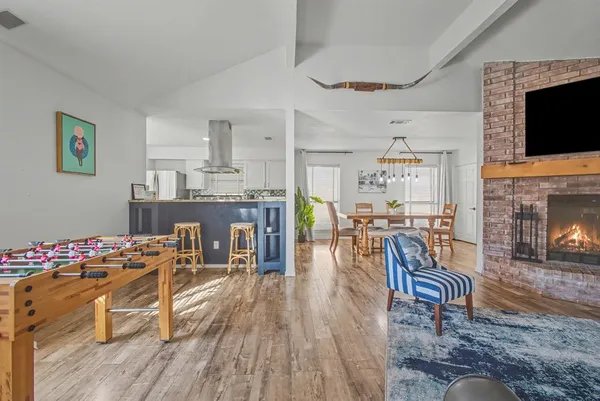 a dining room with furniture garden wooden floor and a fireplace