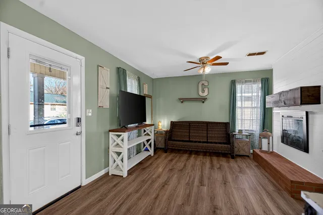 a living room with furniture and a flat screen tv